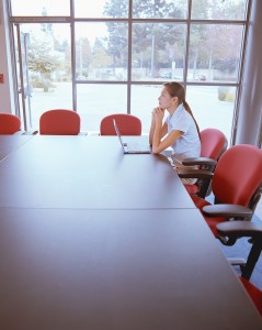 Lone Businesswoman Sitting at Table