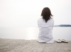 woman sitting by the water