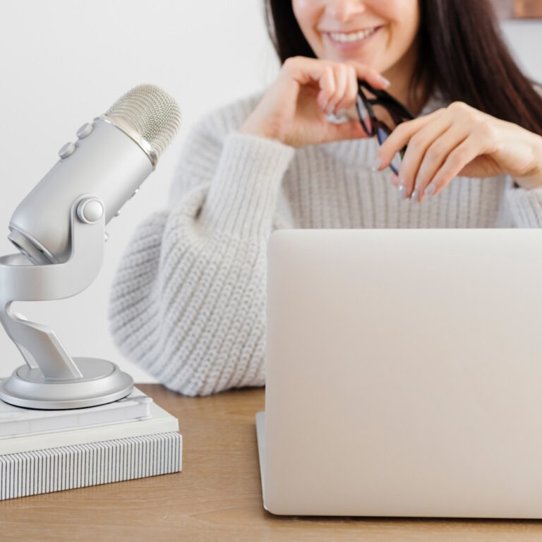 woman using a laptop and mictophone